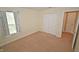 Bedroom featuring neutral carpet, a window with curtains and double closet doors at 6549 Wilshire Pl, Zionsville, IN 46077