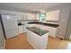 Cozy kitchen featuring white cabinets, granite countertops, and modern appliances at 6549 Wilshire Pl, Zionsville, IN 46077