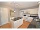 Bright kitchen featuring white cabinets, black countertops, and a convenient center island at 6549 Wilshire Pl, Zionsville, IN 46077