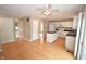 Open concept kitchen with white cabinetry, an island, and hardwood flooring at 6549 Wilshire Pl, Zionsville, IN 46077