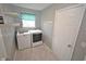 Laundry room with white washer, dryer, shelving and marble pattern flooring at 6549 Wilshire Pl, Zionsville, IN 46077