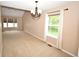 Spacious room with bright windows and modern light fixture at 6549 Wilshire Pl, Zionsville, IN 46077