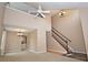 Spacious living room featuring high ceilings, carpet, chandelier, fan, and staircase at 6549 Wilshire Pl, Zionsville, IN 46077