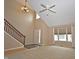 Bright living room boasts high ceilings, staircase, neutral tones, and large windows at 6549 Wilshire Pl, Zionsville, IN 46077