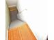Staircase with wood flooring on the landing and white painted walls leading down to the basement at 6549 Wilshire Pl, Zionsville, IN 46077