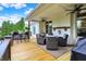 Covered back deck featuring outdoor furniture, ceiling fans, and a beautiful view of the yard making a great outdoor retreat at 6672 Braemar S Ave, Noblesville, IN 46062