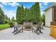 Backyard paver patio with outdoor chairs, a brick retaining wall, and fire pit at 6672 Braemar S Ave, Noblesville, IN 46062