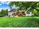 Well-maintained backyard with deck, patio, beautiful lawn, and privacy landscaping at 6672 Braemar S Ave, Noblesville, IN 46062
