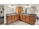 Bathroom with dual sinks, granite countertops, stylish cabinets, and bright lighting at 6672 Braemar S Ave, Noblesville, IN 46062