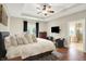 Bright bedroom boasts hardwood floors, a flatscreen television and ensuite bath at 6672 Braemar S Ave, Noblesville, IN 46062