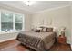 Comfortable bedroom with natural light, hardwood floors, and a serene decor at 6672 Braemar S Ave, Noblesville, IN 46062