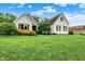 Charming two-story home with manicured lawn, white painted brick, stone accents and beautiful landscaping at 6672 Braemar S Ave, Noblesville, IN 46062