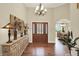 Inviting foyer with hardwood floors, elegant chandelier, and a view into the dining room at 6672 Braemar S Ave, Noblesville, IN 46062