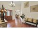 Bright foyer features hardwood floors, an archway and a bench with decorative pillows at 6672 Braemar S Ave, Noblesville, IN 46062