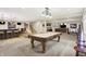 Open basement featuring a pool table, bar area, and comfortable seating creates an ideal entertaining space at 6672 Braemar S Ave, Noblesville, IN 46062