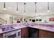 Open kitchen space with granite countertops, updated appliances, and recessed lighting provides a modern, functional space at 6672 Braemar S Ave, Noblesville, IN 46062