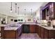 Basement kitchen area with granite countertops, pendant lighting, and modern appliances offers a great space for entertaining at 6672 Braemar S Ave, Noblesville, IN 46062