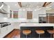 Well-lit kitchen with stainless steel appliances, island with seating and hardwood floors at 6672 Braemar S Ave, Noblesville, IN 46062