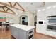 Spacious open kitchen with beamed ceilings, island, stainless appliances and hardwood floors at 6672 Braemar S Ave, Noblesville, IN 46062