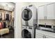 Convenient laundry room with stacked washer/dryer, closet, and sink with granite countertop at 6672 Braemar S Ave, Noblesville, IN 46062