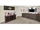 Cozy basement living room featuring custom built-ins, sports memorabilia, and plush seating provides a relaxed living space at 6672 Braemar S Ave, Noblesville, IN 46062