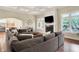Open-concept living room with hardwood floors, fireplace and large sectional sofa at 6672 Braemar S Ave, Noblesville, IN 46062