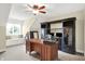 Home office with window seat, ceiling fan, dark wood built-ins, and a large desk at 6672 Braemar S Ave, Noblesville, IN 46062