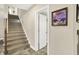 Carpeted staircase next to a framed image and open doorway at 6672 Braemar S Ave, Noblesville, IN 46062
