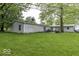 Expansive backyard featuring mature trees and well-maintained lawn; ideal for outdoor activities at 6691 S County Road 350 W, Clayton, IN 46118