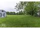 Expansive backyard featuring lush greenery, mature trees and manicured lawn at 6691 S County Road 350 W, Clayton, IN 46118