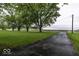 Long paved driveway with mature trees lining the left side of the driveway at 6691 S County Road 350 W, Clayton, IN 46118