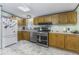 Functional kitchen with stainless steel appliances, wooden cabinetry, and ample counter space at 6691 S County Road 350 W, Clayton, IN 46118