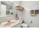 Well-lit bathroom with a clean vanity, neutral colored tiling, and organized towel racks at 6711 Bridgefield Way, Indianapolis, IN 46254