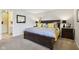 Bedroom features carpeted floors, neutral walls, and a large bed at 6711 Bridgefield Way, Indianapolis, IN 46254