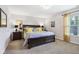 Comfortable main bedroom with a large bed, neutral walls, and carpet flooring at 6711 Bridgefield Way, Indianapolis, IN 46254