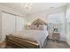 Well-lit bedroom with a striking chandelier, mirrored furniture, and carpeted floors at 6711 Bridgefield Way, Indianapolis, IN 46254