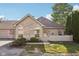 Charming brick home featuring well-manicured landscaping and a quaint, fenced front yard at 6711 Bridgefield Way, Indianapolis, IN 46254