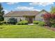 Charming single-story brick home with a well-manicured lawn and beautiful landscaping at 6711 Bridgefield Way, Indianapolis, IN 46254