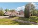 Attractive home with brick accents, landscaping, and a fenced front yard on a sunny day at 6711 Bridgefield Way, Indianapolis, IN 46254