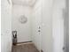 Bright hallway with neutral colors, a decorative mirror, and closet space at 6711 Bridgefield Way, Indianapolis, IN 46254