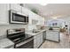 Modern kitchen featuring stainless steel appliances and white cabinetry at 6711 Bridgefield Way, Indianapolis, IN 46254