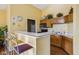 A kitchen with oak cabinets, white countertop, bar stools, and stainless steel appliances at 6711 Bridgefield Way, Indianapolis, IN 46254