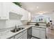Bright kitchen features white cabinets, stainless steel appliances, and granite countertops at 6711 Bridgefield Way, Indianapolis, IN 46254