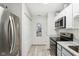 Kitchen featuring stainless steel appliances, white cabinets, and a pantry at 6711 Bridgefield Way, Indianapolis, IN 46254
