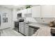 Well-lit kitchen equipped with stainless steel appliances and bright white cabinets at 6711 Bridgefield Way, Indianapolis, IN 46254