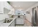 Well-lit kitchen with white cabinetry, stainless appliances, and an open layout at 6711 Bridgefield Way, Indianapolis, IN 46254