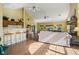 A spacious living room with bar stools, couches, and ceiling fans at 6711 Bridgefield Way, Indianapolis, IN 46254
