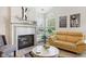Bright living room featuring a fireplace, yellow sofas, and vaulted ceilings at 6711 Bridgefield Way, Indianapolis, IN 46254