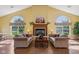 Inviting living room with vaulted ceilings, fireplace, and arched windows at 6711 Bridgefield Way, Indianapolis, IN 46254