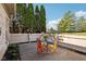 Outdoor patio space with colorful seating, privacy fence and green trees at 6711 Bridgefield Way, Indianapolis, IN 46254